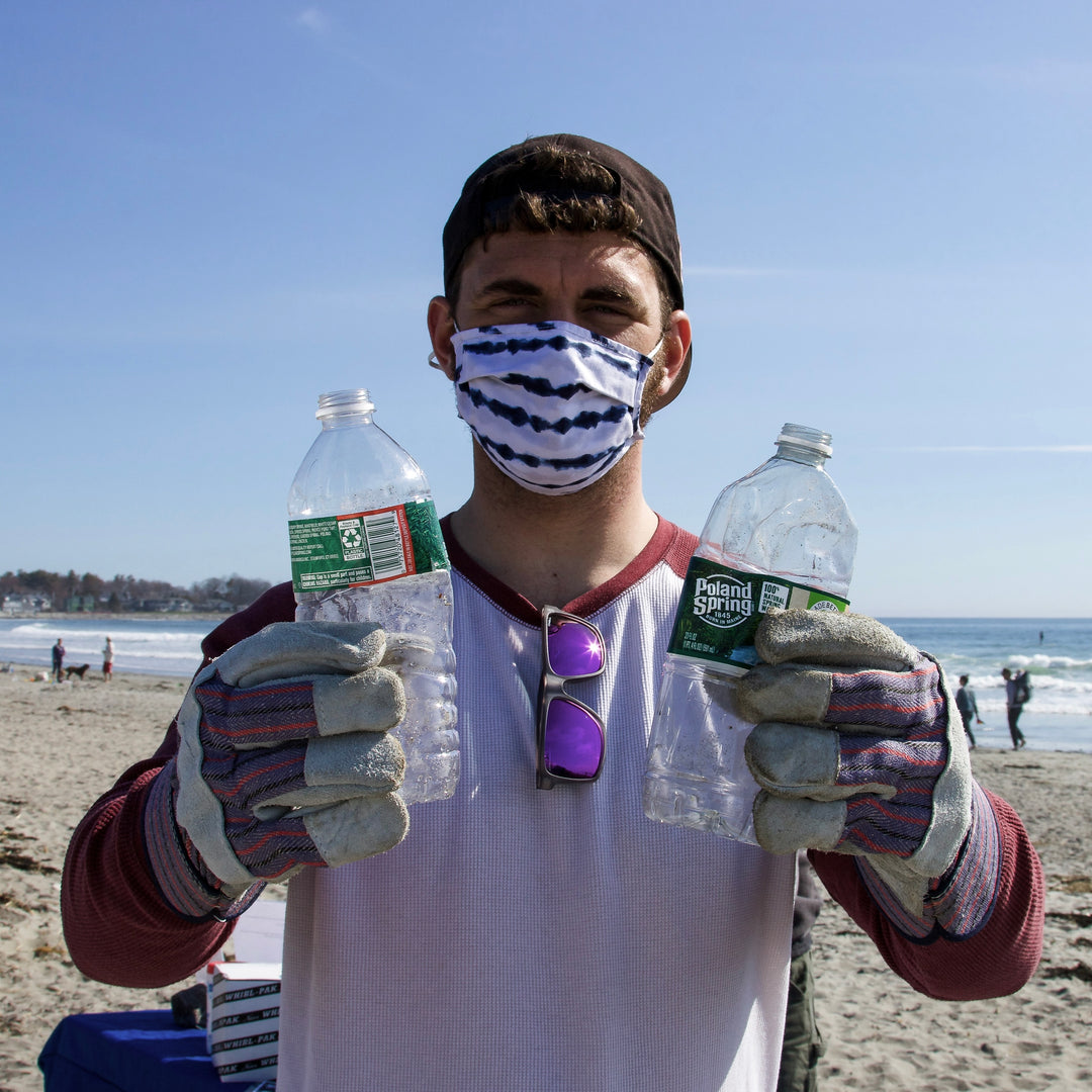 a man holding plastic bottle collect from the beach
